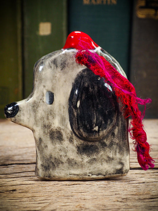 Handmade ceramic dog ornament with winter hoodie, created by Idania Salcido aka Danita Art for Christmas decorating or gifting.