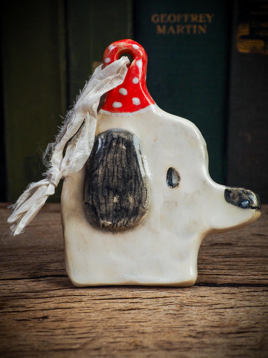 Handmade ceramic dog ornament with winter hoodie, created by Idania Salcido aka Danita Art for Christmas decorating or gifting.
