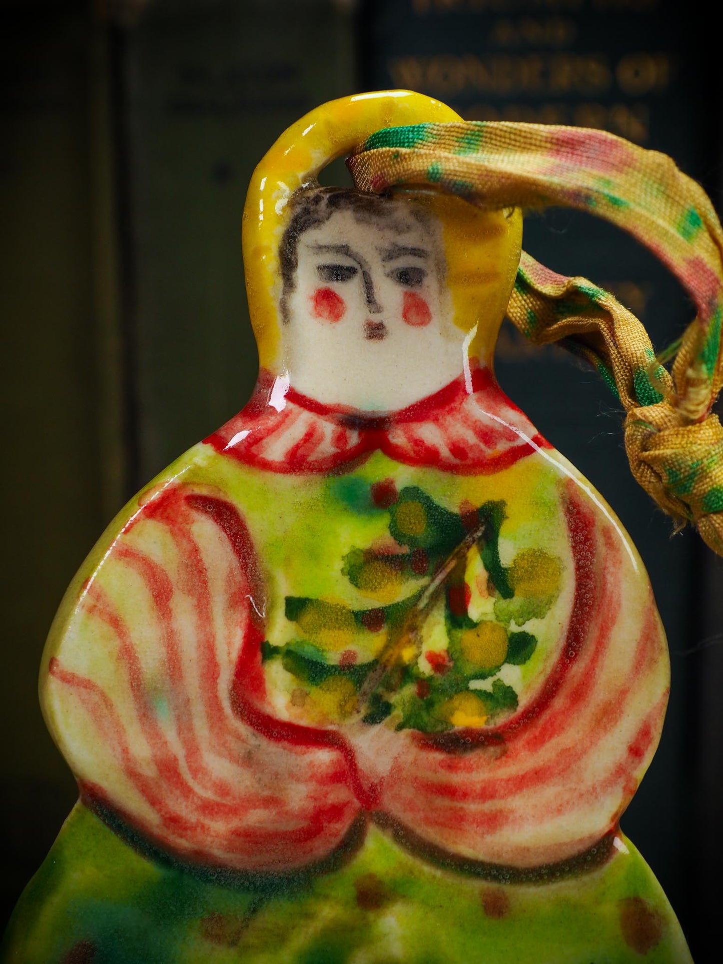 Handmade ceramic winter figure ornament with green dress and painted details, created by Idania Salcido aka Danita Art for Christmas decoration or gifting.