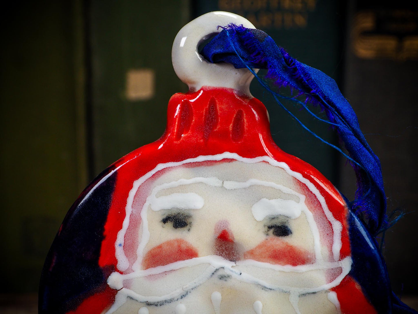 Handmade ceramic Santa ornament with blue ribbon by Idania Salcido aka Danita Art.