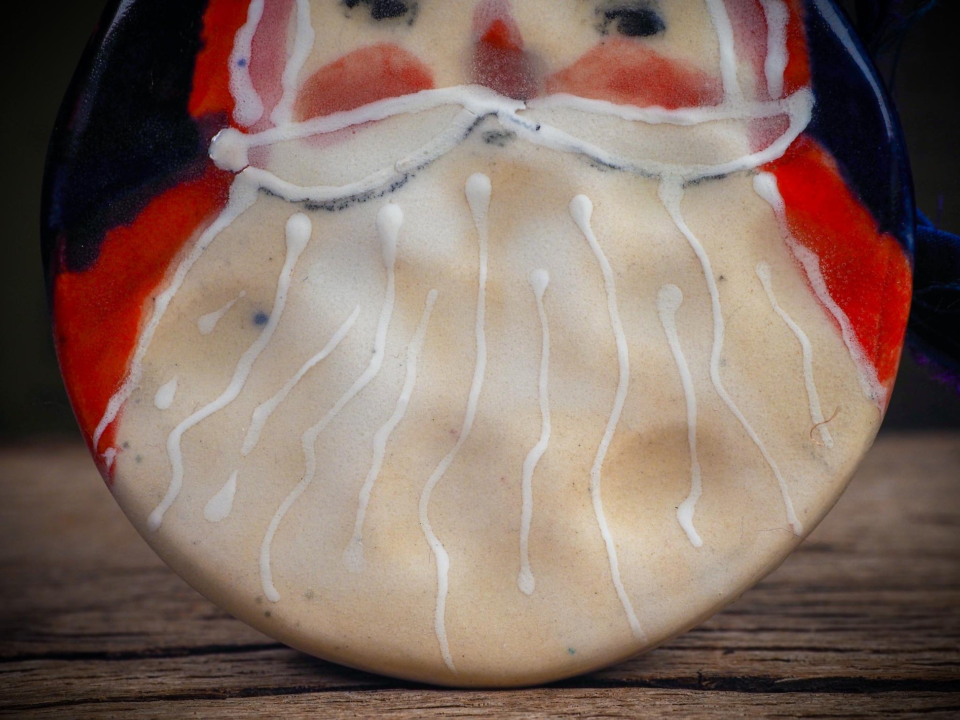 Handmade ceramic Santa ornament with blue ribbon by Idania Salcido aka Danita Art.