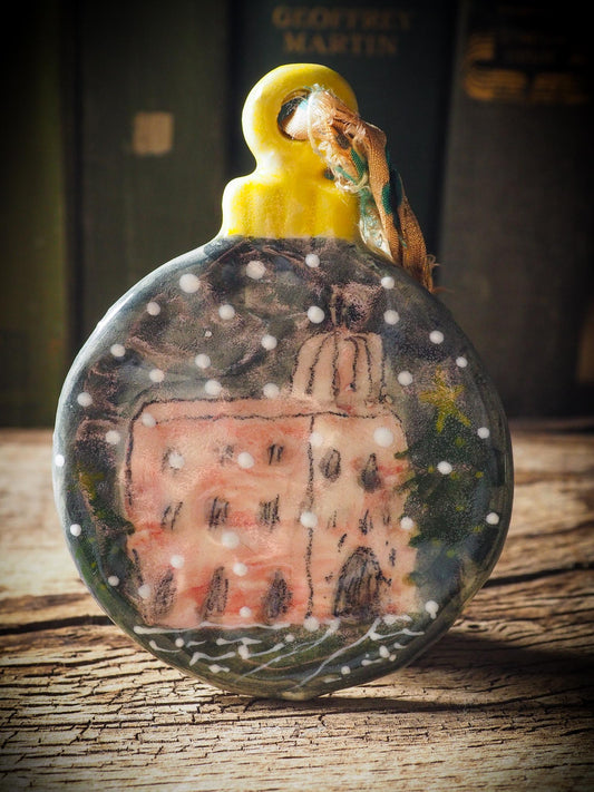Handmade ceramic ornament with a snowy Christmas house by Idania Salcido aka Danita Art.