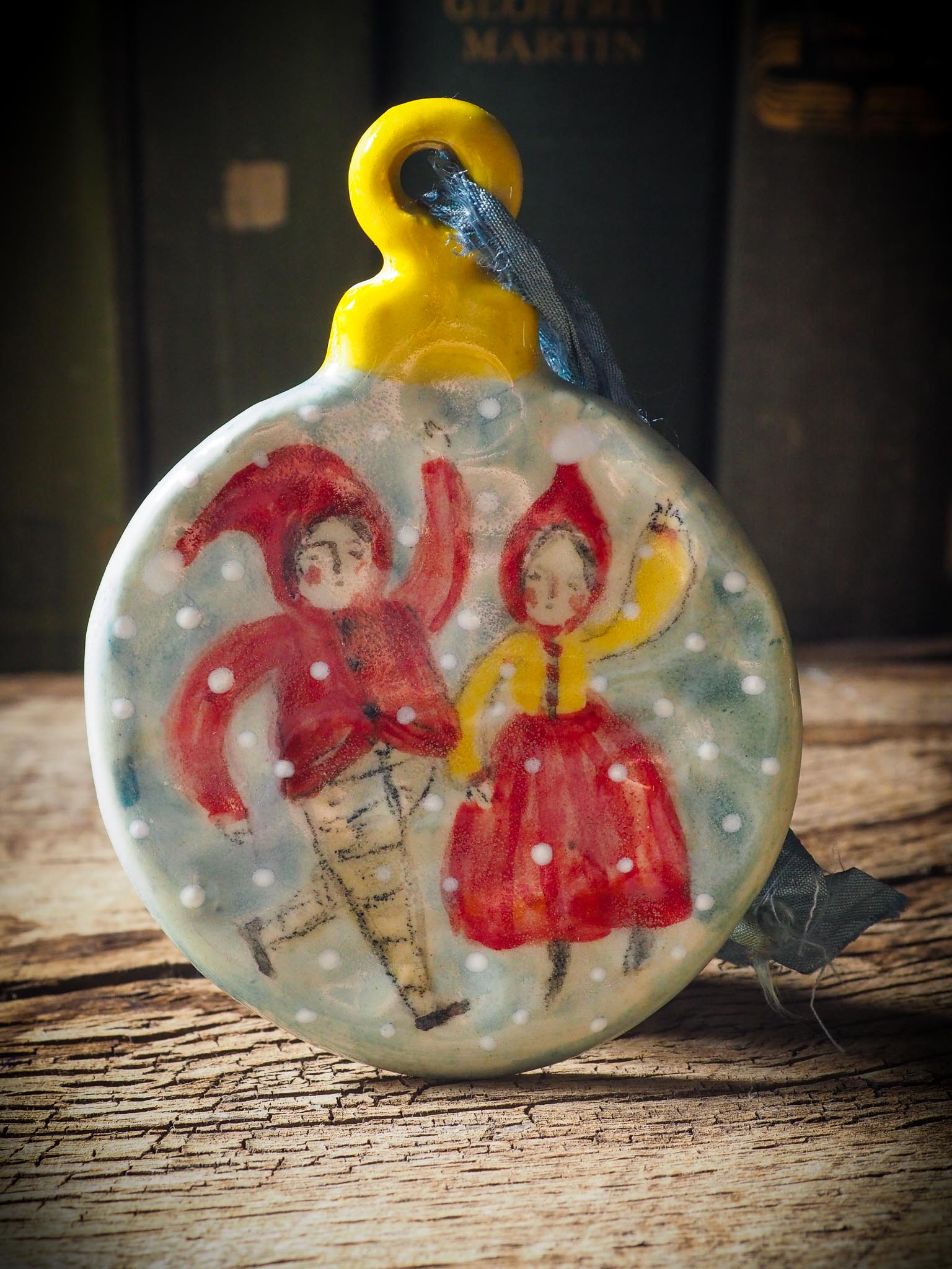 Handmade ceramic ornament with two dancing Christmas elves by Idania Salcido aka Danita Art.