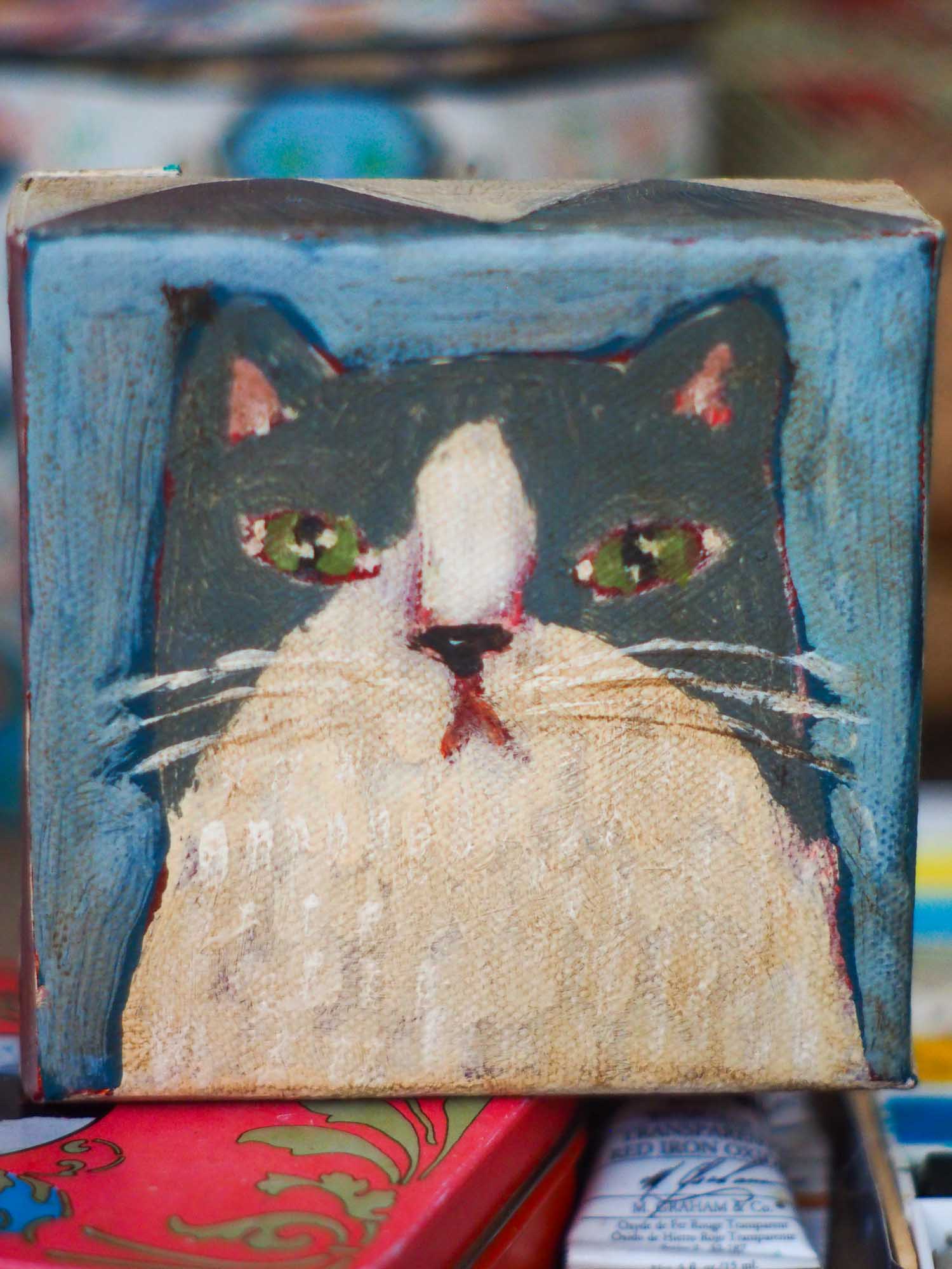 An original acrylic painting by Idania Salcido, Danita Art, depicting a grey cat posing on a serious pose. A cat doing cat things.