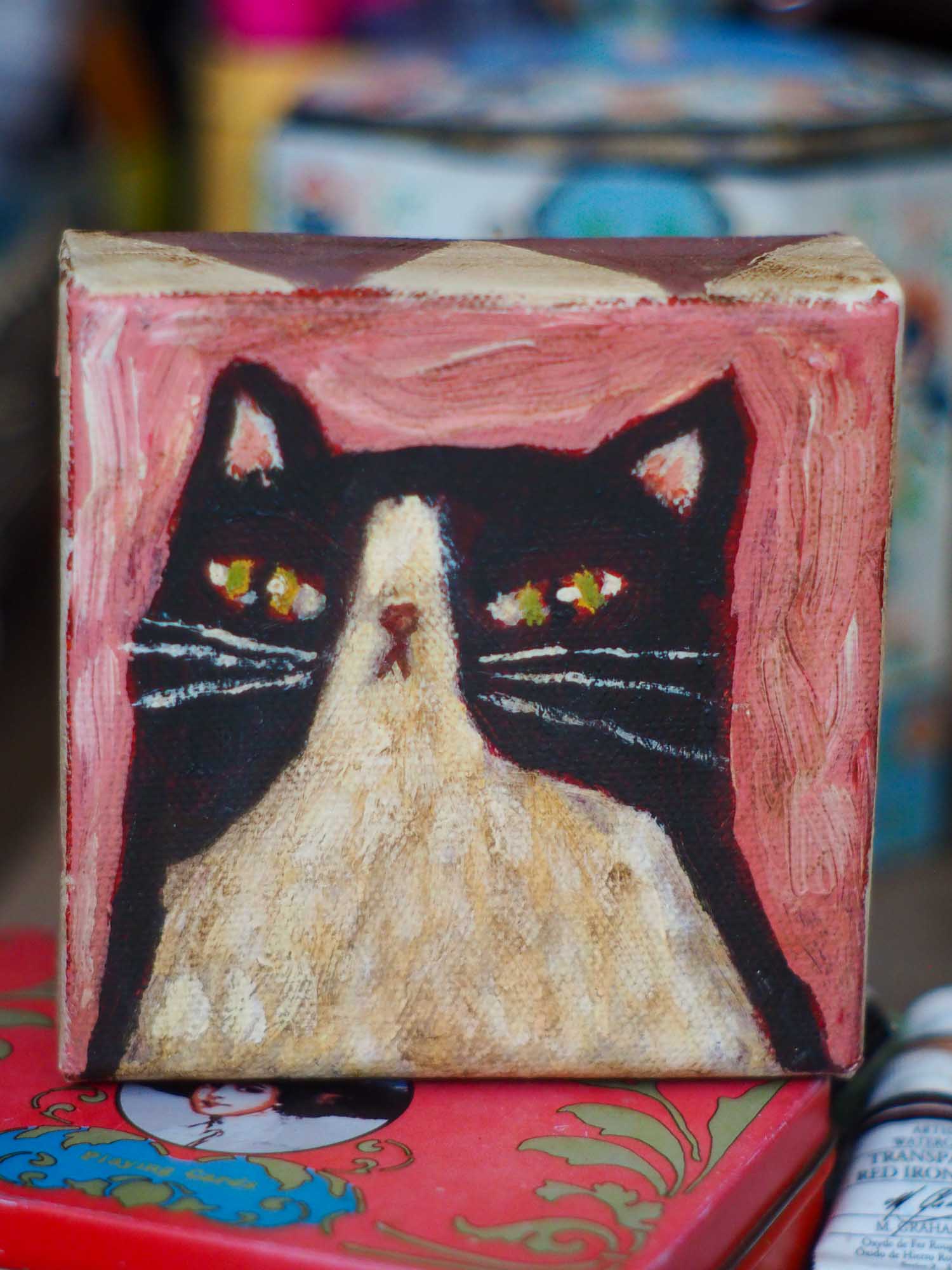 An original acrylic painting by Idania Salcido, Danita Art, depicting a tuxedo cat posing on a serious pose. A cat doing cat things.