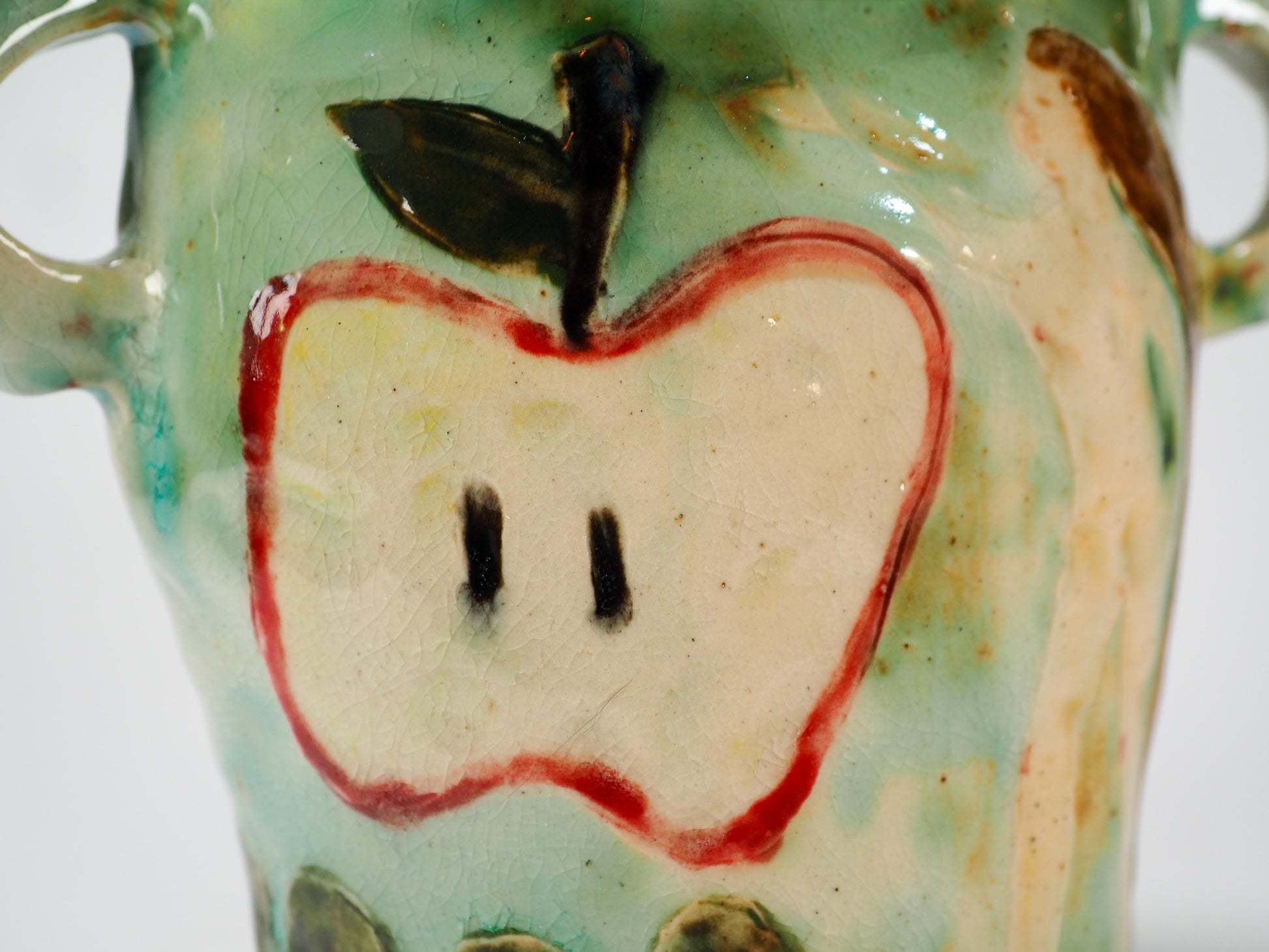 We Could Say No feminist ceramic art vase by Idania Salcido Danita Art featuring carved relief Adam & Eve reaching toward a sliced apple while the serpents lurks nearby.