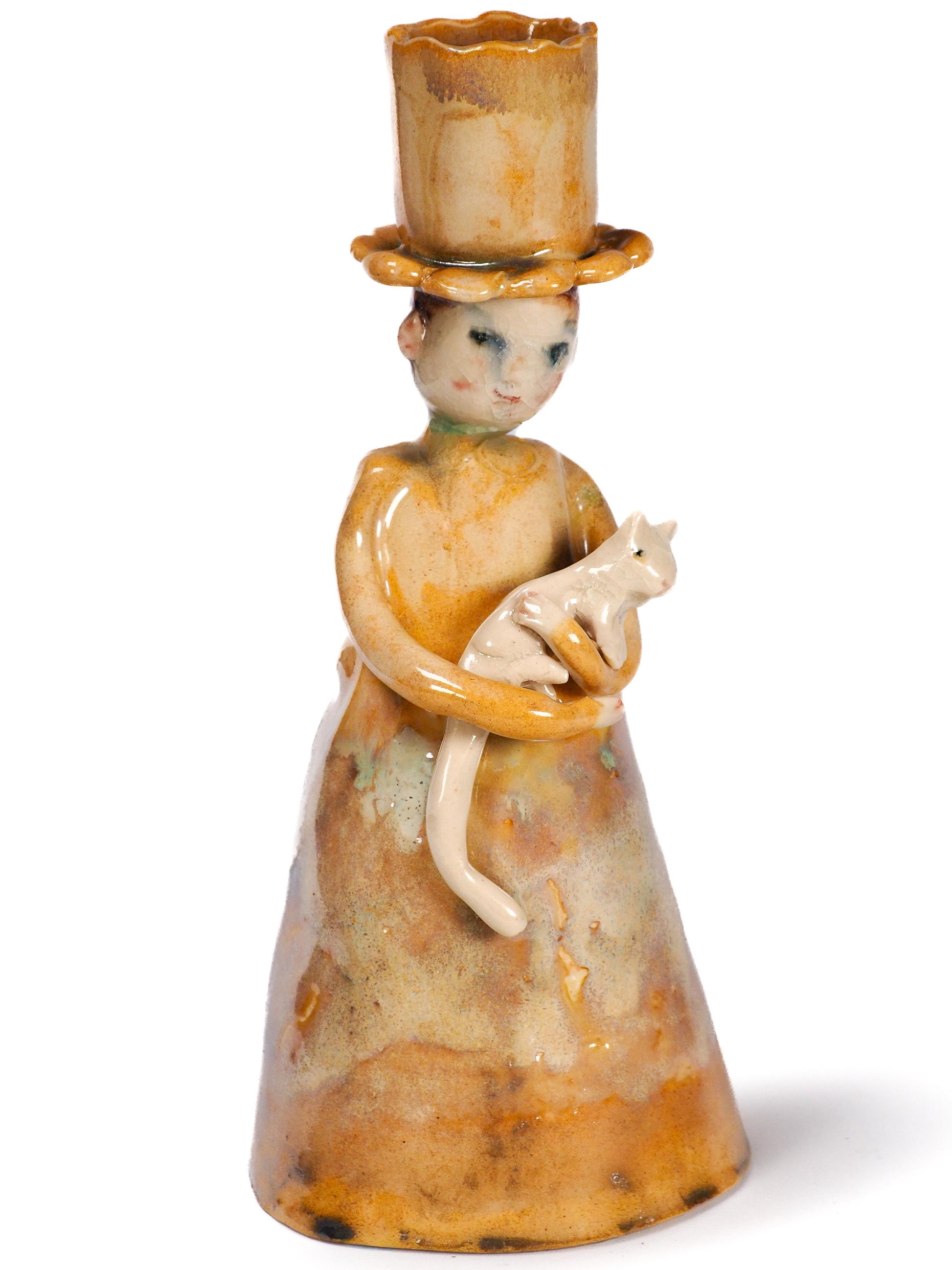 A vintage ceramic figurine by Idania Salcido (Danita Art) of a woman in a tall hat holding a cat, shown on a plain white background.