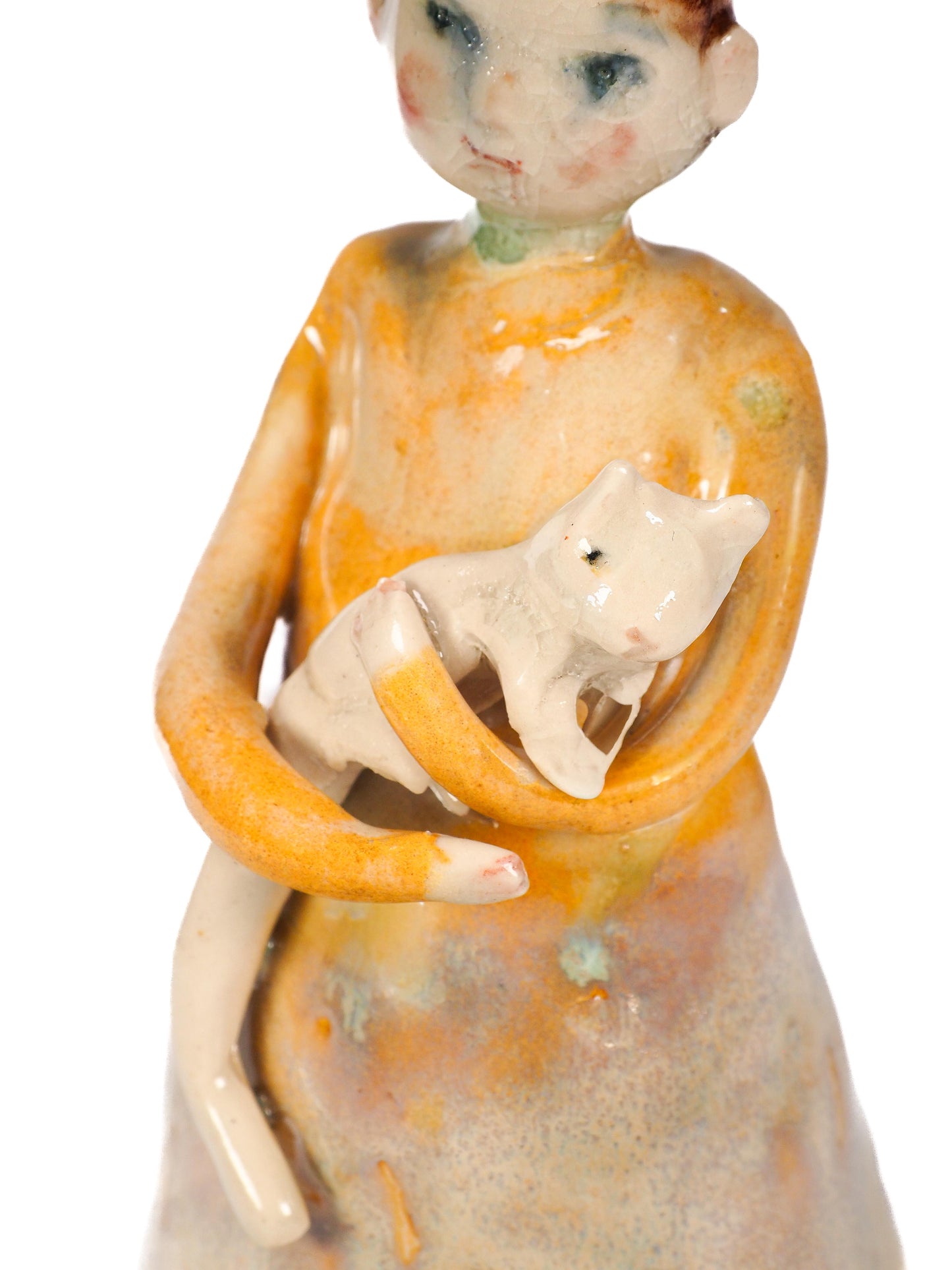 A ceramic figurine of a woman in a flowing dress holding a small cat, shown against a plain white background. By Idania Salcido (Danita Art)