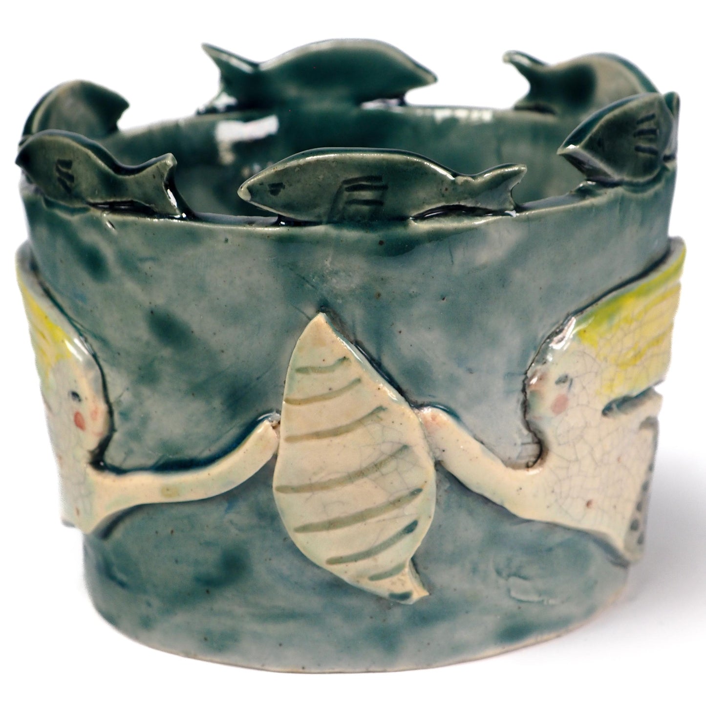 A handmade ceramic fish-shaped bowl with a dark green glazed finish, featuring a large yellow and white fish motif on the front and smaller fish protruding from the rim by Idania Salcido (Danita Art).