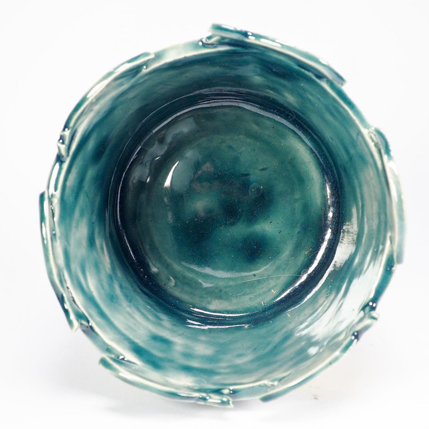 A handmade ceramic fish-shaped bowl with a dark green glazed finish, featuring a large yellow and white fish motif on the front and smaller fish protruding from the rim by Idania Salcido (Danita Art).