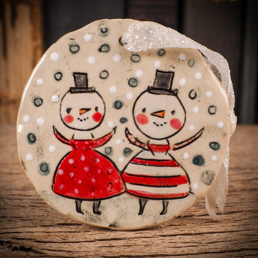 An original Christmas Holiday tree round glazed ceramic ornament handmade by Idania Salcido, the artist behind Danita Art. Glazed carved sgraffito stoneware, hand painted and decorated, it is illustrated by hand with winter scenes with snowmen, Christmas trees, Santa Claus, snow balls and winter themes.