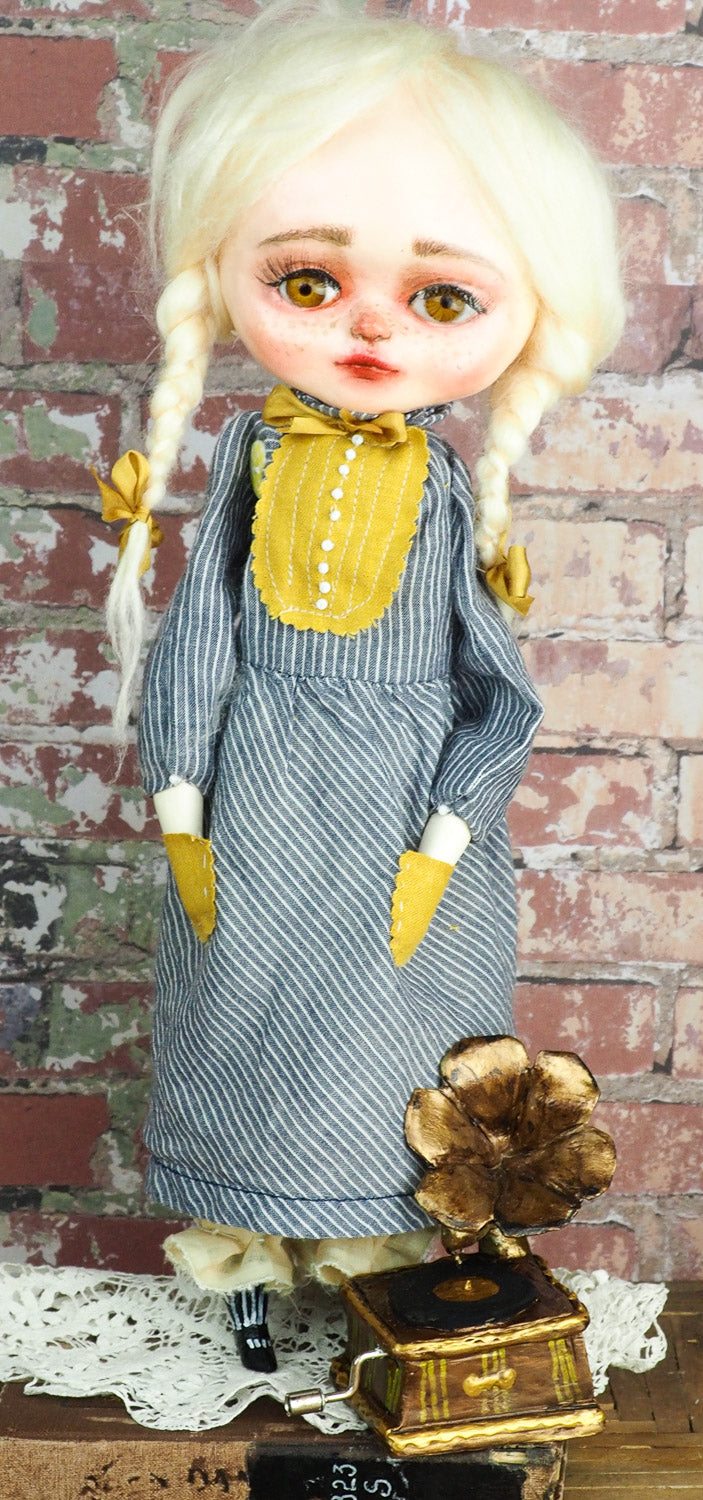 An original hand crafted art doll made by Danita. A blonde girl with a love for music, she plays her vintage vinyl records on her antique gramophone.