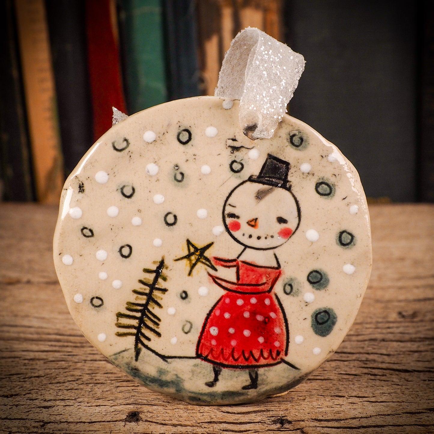 An original Christmas Holiday tree round glazed ceramic ornament handmade by Idania Salcido, the artist behind Danita Art. Glazed carved sgraffito stoneware, hand painted and decorated, it is illustrated by hand with winter scenes with snowmen, Christmas trees, Santa Claus, snow balls and winter themes.