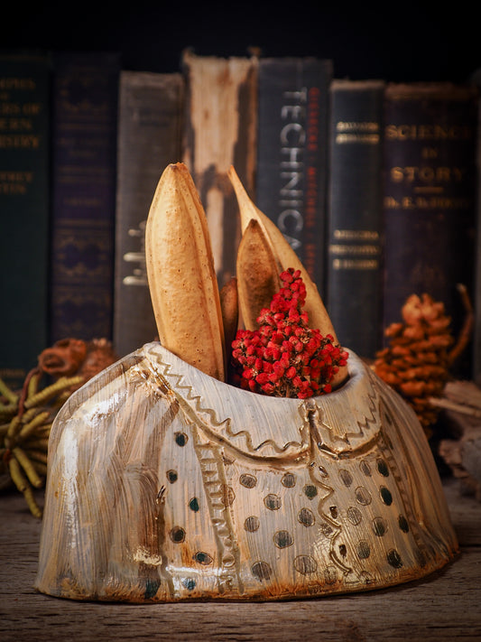 Using hand pinching techniques in of a kind fire glazed ceramics, Idania Salcido, the artist behind Danita Art, sculpted glazed ceramic clay vase containers and flower pots in the shape of vintage blouses. Beautiful accents for your dinner table, showcase or anywhere you want to remind you of family and love.