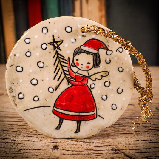 An original Christmas Holiday tree round glazed ceramic ornament handmade by Idania Salcido, the artist behind Danita Art. Glazed carved sgraffito stoneware, hand painted and decorated, it is illustrated by hand with winter scenes with snowmen, Christmas trees, Santa Claus, snow balls and winter themes.