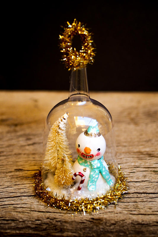 An original handmade christmas tree ornament by Idania Salcido. A clear domed diorama with a holiday scene with Santa Claus elves, Christmas Trees, Elves, Gifts and magical glitter deer. Perfect to decorate your Christmas Tree, your mantelpiece or to be used as accents on a dinner table.