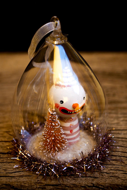 An original handmade christmas tree ornament by Idania Salcido. A clear domed diorama with a holiday scene with Santa Claus elves, Christmas Trees, Elves, Gifts and magical glitter deer. Perfect to decorate your Christmas Tree, your mantelpiece or to be used as accents on a dinner table.
