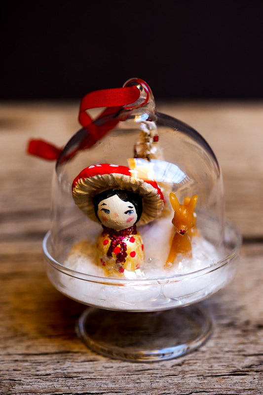 An original handmade christmas tree ornament by Idania Salcido. A clear domed diorama with a holiday scene with Santa Claus elves, Christmas Trees, Elves, Gifts and magical glitter deer. Perfect to decorate your Christmas Tree, your mantelpiece or to be used as accents on a dinner table.