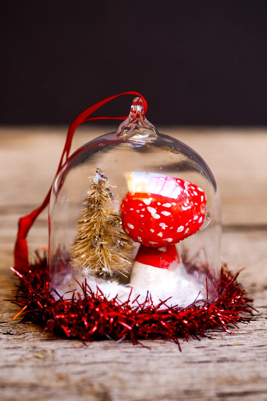 An original handmade christmas tree ornament by Idania Salcido. A clear domed diorama with a holiday scene with Santa Claus elves, Christmas Trees, Elves, Gifts and magical glitter deer. Perfect to decorate your Christmas Tree, your mantelpiece or to be used as accents on a dinner table.