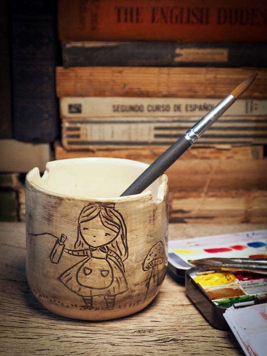 I made this ceramic paint water holder for artists like you and me. It's handmade on my studio by me, Idania Salcido, the artist behind Danita Art. It's glazed and made to hold water for brushes, with a little notch on top to hold your favorite brush and it can be used with acrylics, oils and watercolors.