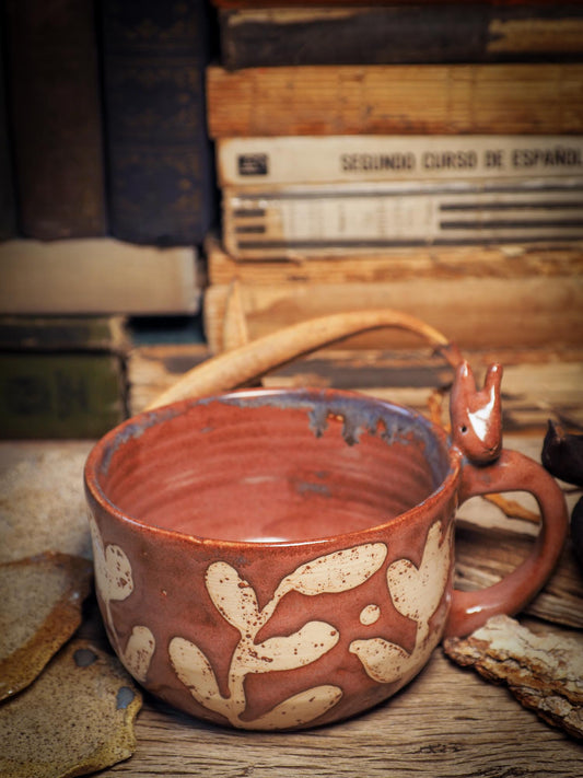 Handmade carved ceramic coffee mug created by Idania Salcido, the artist behind Danita Art, and fired and glazed on my own kiln. The inside is a beautiful combination of brown and blue glazes, combining inside like cream and coffee. A bunny rabbit on the handle and flowers on the sides make it a unique item decoration.