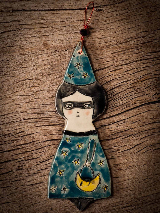 An original handmade Halloween ornament by Idania Salcido, Danita Art. Each ornament is hand carved with pumpkins, witches, cats, jack-o-lanterns and moons.  Made with fired glazed ceramics, this little witch, jack-o-lantern and cat is carved with delicate patterns that make each ornament a one of a kind work of art.