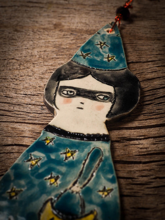 An original handmade Halloween ornament by Idania Salcido, Danita Art. Each ornament is hand carved with pumpkins, witches, cats, jack-o-lanterns and moons.  Made with fired glazed ceramics, this little witch, jack-o-lantern and cat is carved with delicate patterns that make each ornament a one of a kind work of art.