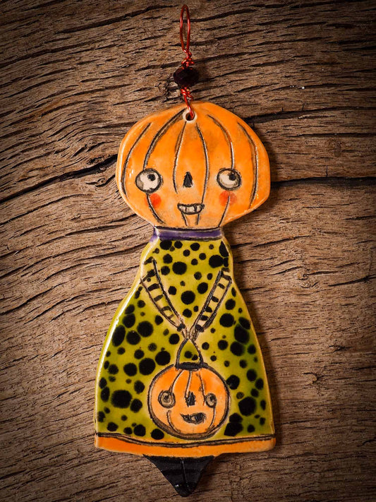 An original handmade Halloween ornament by Idania Salcido, Danita Art. Each ornament is hand carved with pumpkins, witches, cats, jack-o-lanterns and moons.  Made with fired glazed ceramics, this little witch, jack-o-lantern and cat is carved with delicate patterns that make each ornament a one of a kind work of art.