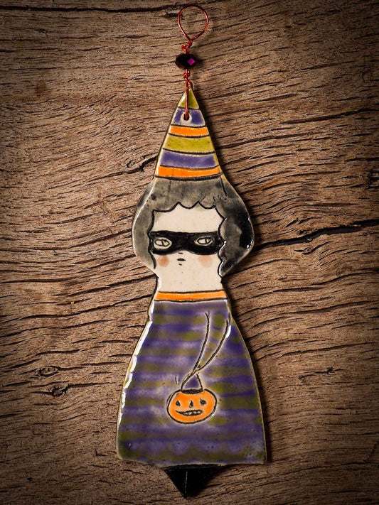An original handmade Halloween ornament by Idania Salcido, Danita Art. Each ornament is hand carved with pumpkins, witches, cats, jack-o-lanterns and moons.  Made with fired glazed ceramics, this little witch, jack-o-lantern and cat is carved with delicate patterns that make each ornament a one of a kind work of art.