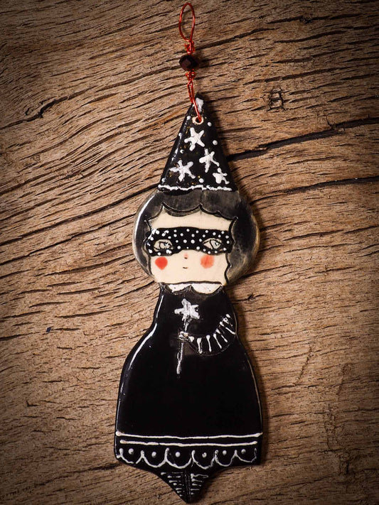 An original handmade Halloween ornament by Idania Salcido, Danita Art. Each ornament is hand carved with pumpkins, witches, cats, jack-o-lanterns and moons.  Made with fired glazed ceramics, this little witch, jack-o-lantern and cat is carved with delicate patterns that make each ornament a one of a kind work of art.