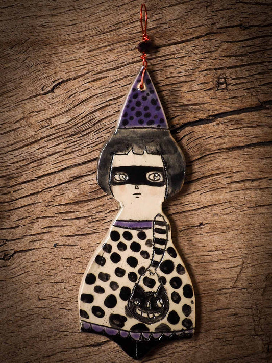 An original handmade Halloween ornament by Idania Salcido, Danita Art. Each ornament is hand carved with pumpkins, witches, cats, jack-o-lanterns and moons.  Made with fired glazed ceramics, this little witch, jack-o-lantern and cat is carved with delicate patterns that make each ornament a one of a kind work of art.