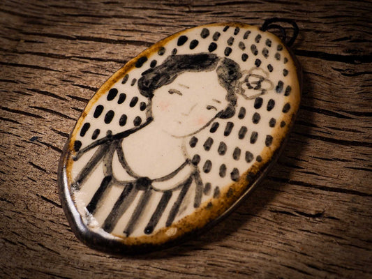 Unique fired ceramic porcelain necklace oval pendant by Idania Salcido, the artist behind Danita Art. Each jewelry setting is hand drawn and illustrated by the artist in her art studio, perfect for any dressing style. A casual gathering with friends or a fancy formal dinner, this necklace is a perfect fashion accessory.