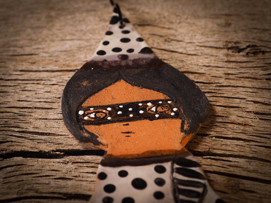 An original handmade Halloween ornament by Idania Salcido, Danita Art. Each ornament is hand carved with pumpkins, witches, cats, jack-o-lanterns and moons.  Made with fired glazed ceramics, this little witch, jack-o-lantern and cat is carved with delicate patterns that make each ornament a one of a kind work of art.