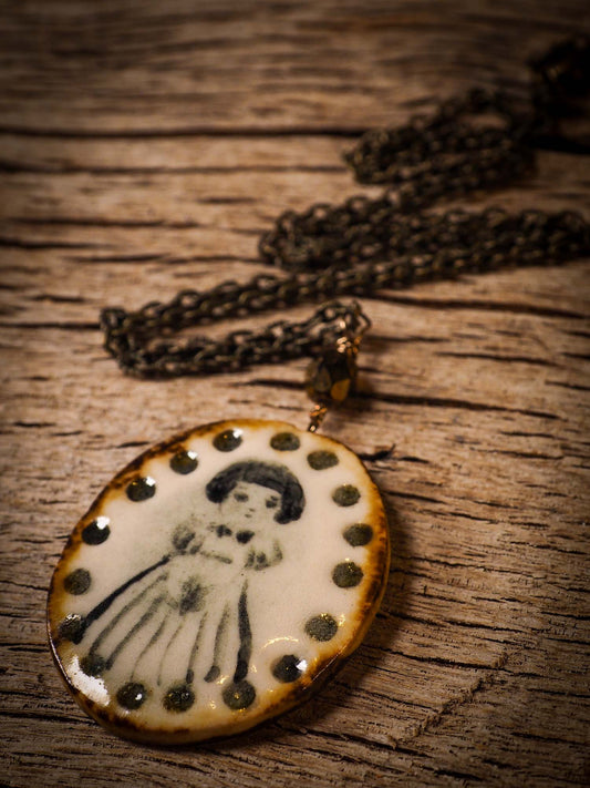 Unique fired ceramic porcelain necklace oval pendant by Idania Salcido, the artist behind Danita Art. Each jewelry setting is hand drawn and illustrated by the artist in her art studio, perfect for any dressing style. A casual gathering with friends or a fancy formal dinner, this necklace is a perfect fashion accessory.