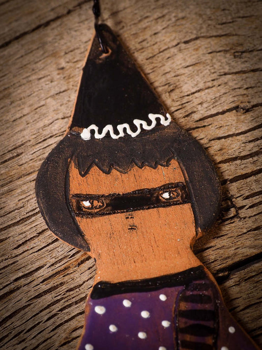 An original handmade Halloween ornament by Idania Salcido, Danita Art. Each ornament is hand carved with pumpkins, witches, cats, jack-o-lanterns and moons.  Made with fired glazed ceramics, this little witch, jack-o-lantern and cat is carved with delicate patterns that make each ornament a one of a kind work of art.