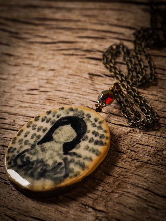 Unique fired ceramic porcelain necklace oval pendant by Idania Salcido, the artist behind Danita Art. Each jewelry setting is hand drawn and illustrated by the artist in her art studio, perfect for any dressing style. A casual gathering with friends or a fancy formal dinner, this necklace is a perfect fashion accessory.