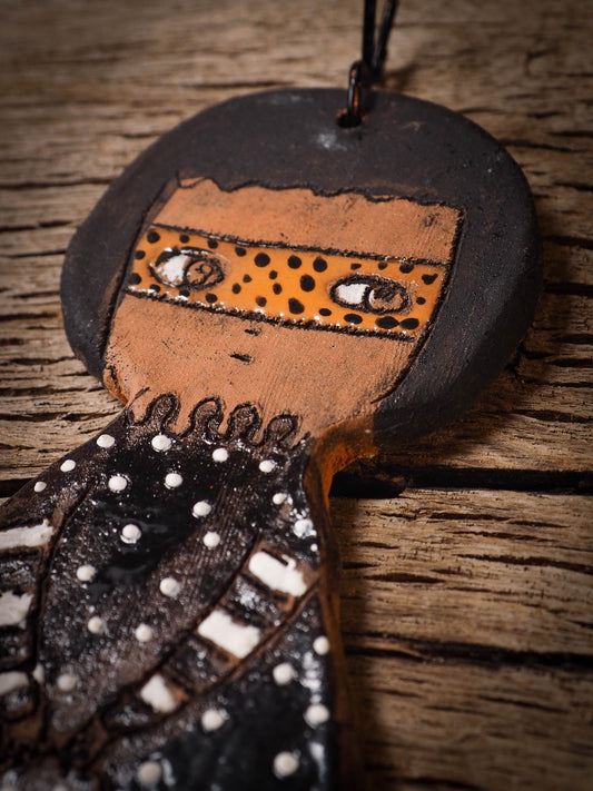 An original handmade Halloween ornament by Idania Salcido, Danita Art. Each ornament is hand carved with pumpkins, witches, cats, jack-o-lanterns and moons.  Made with fired glazed ceramics, this little witch, jack-o-lantern and cat is carved with delicate patterns that make each ornament a one of a kind work of art.