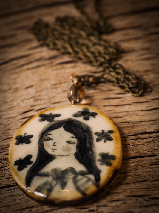 Unique fired ceramic porcelain necklace oval pendant by Idania Salcido, the artist behind Danita Art. Each jewelry setting is hand drawn and illustrated by the artist in her art studio, perfect for any dressing style. A casual gathering with friends or a fancy formal dinner, this necklace is a perfect fashion accessory.