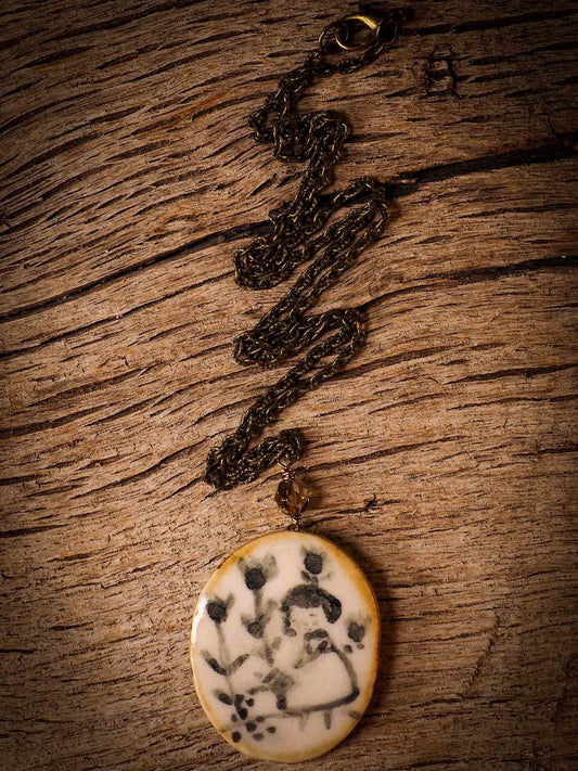 Unique fired ceramic porcelain necklace oval pendant by Idania Salcido, the artist behind Danita Art. Each jewelry setting is hand drawn and illustrated by the artist in her art studio, perfect for any dressing style. A casual gathering with friends or a fancy formal dinner, this necklace is a perfect fashion accessory.