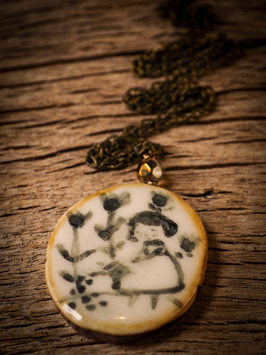 Unique fired ceramic porcelain necklace oval pendant by Idania Salcido, the artist behind Danita Art. Each jewelry setting is hand drawn and illustrated by the artist in her art studio, perfect for any dressing style. A casual gathering with friends or a fancy formal dinner, this necklace is a perfect fashion accessory.