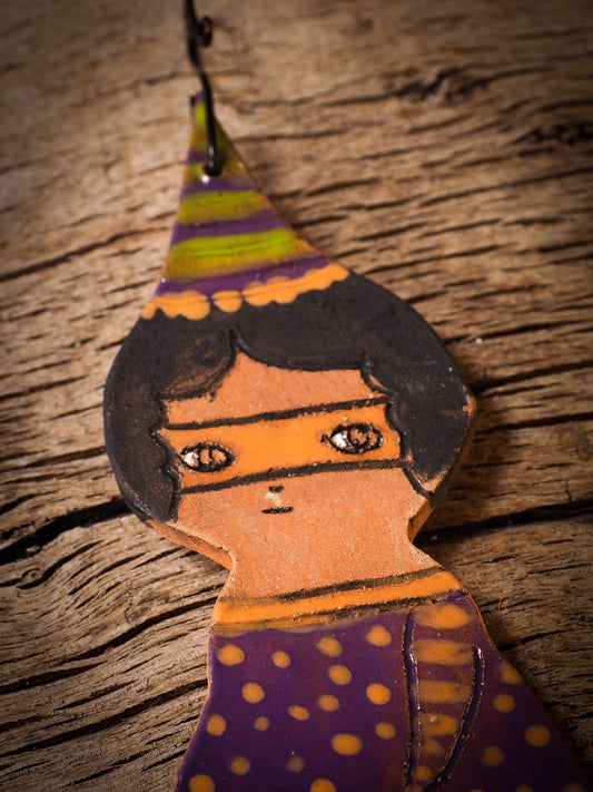 An original handmade Halloween ornament by Idania Salcido, Danita Art. Each ornament is hand carved with pumpkins, witches, cats, jack-o-lanterns and moons.  Made with fired glazed ceramics, this little witch, jack-o-lantern and cat is carved with delicate patterns that make each ornament a one of a kind work of art.