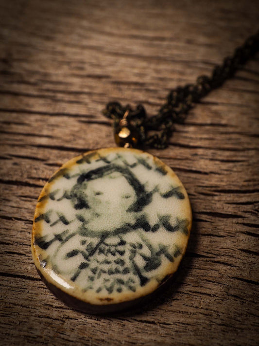 Unique fired ceramic porcelain necklace oval pendant by Idania Salcido, the artist behind Danita Art. Each jewelry setting is hand drawn and illustrated by the artist in her art studio, perfect for any dressing style. A casual gathering with friends or a fancy formal dinner, this necklace is a perfect fashion accessory.
