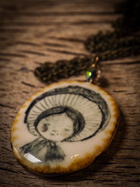 Unique fired ceramic porcelain necklace oval pendant by Idania Salcido, the artist behind Danita Art. Each jewelry setting is hand drawn and illustrated by the artist in her art studio, perfect for any dressing style. A casual gathering with friends or a fancy formal dinner, this necklace is a perfect fashion accessory.