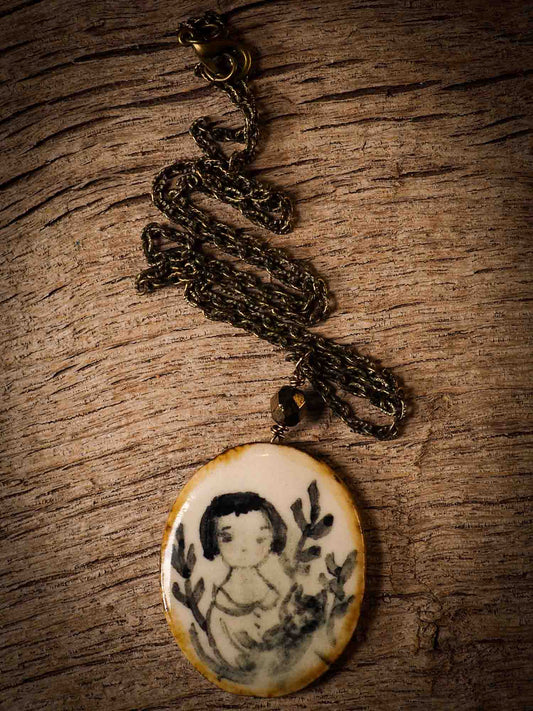 Unique fired ceramic porcelain necklace oval pendant by Idania Salcido, the artist behind Danita Art. Each jewelry setting is hand drawn and illustrated by the artist in her art studio, perfect for any dressing style. A casual gathering with friends or a fancy formal dinner, this necklace is a perfect fashion accessory.