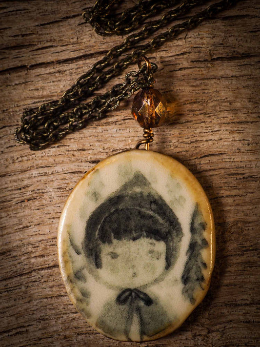 Unique fired ceramic porcelain necklace oval pendant by Idania Salcido, the artist behind Danita Art. Each jewelry setting is hand drawn and illustrated by the artist in her art studio, perfect for any dressing style. A casual gathering with friends or a fancy formal dinner, this necklace is a perfect fashion accessory.