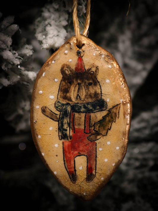 An original Christmas Holiday tree round glazed ceramic ornament handmade by Idania Salcido, the artist behind Danita Art. Glazed carved sgraffito stoneware, hand painted and decorated, it is illustrated by hand with snowmen, Christmas trees, Santa Claus, angels and snow balls and winter themes.