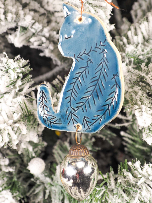 An original Christmas Holiday tree ornament ceramic cat, handmade by Idania Salcido the artist behind Danita Art. Glazed carved sgraffito stoneware, hand painted and decorated, it has a beautiful vintage glass tree ornament to adorn a unique holiday gift for family and friends. Christmas gift for animal and pet lovers.