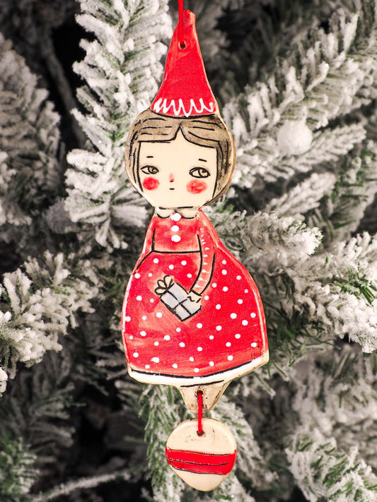 An original Christmas Holiday tree round glazed ceramic ornament handmade by Idania Salcido, the artist behind Danita Art. Glazed carved sgraffito stoneware, hand painted and decorated, it is illustrated by hand with snowmen, Christmas trees, Santa Claus, angels and snow balls and winter themes.