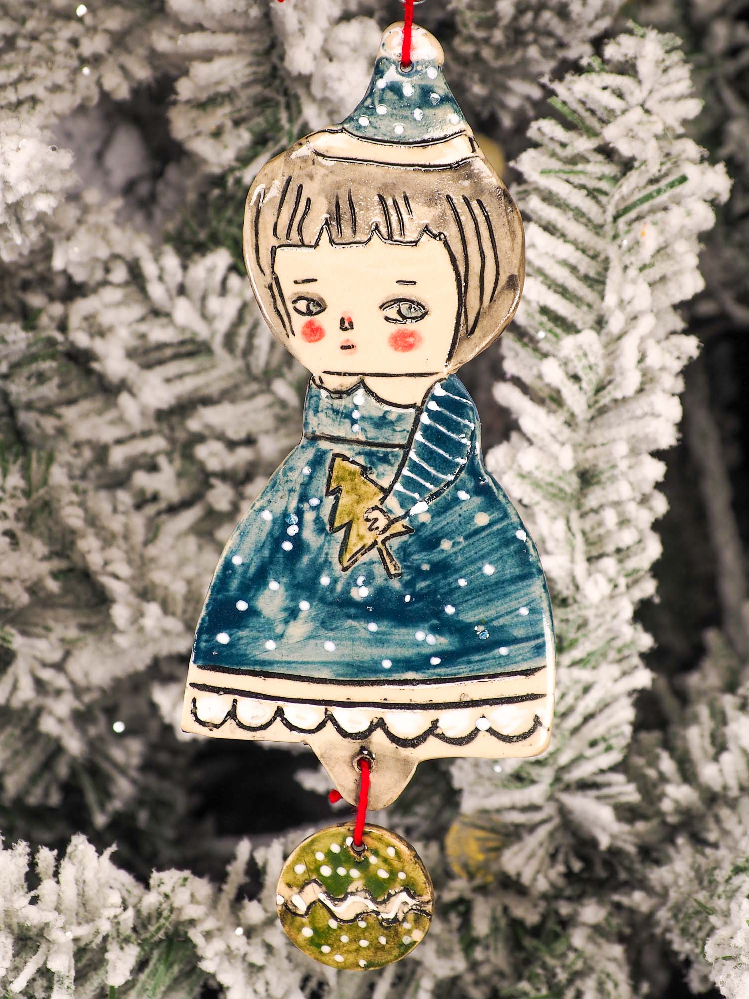 An original Christmas Holiday tree round glazed ceramic ornament handmade by Idania Salcido, the artist behind Danita Art. Glazed carved sgraffito stoneware, hand painted and decorated, it is illustrated by hand with snowmen, Christmas trees, Santa Claus, angels and snow balls and winter themes.