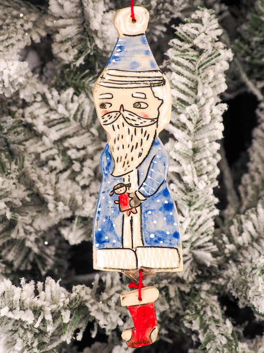 An original Christmas Holiday tree round glazed ceramic ornament handmade by Idania Salcido, the artist behind Danita Art. Glazed carved sgraffito stoneware, hand painted and decorated, it is illustrated by hand with snowmen, Christmas trees, Santa Claus, angels and snow balls and winter themes.